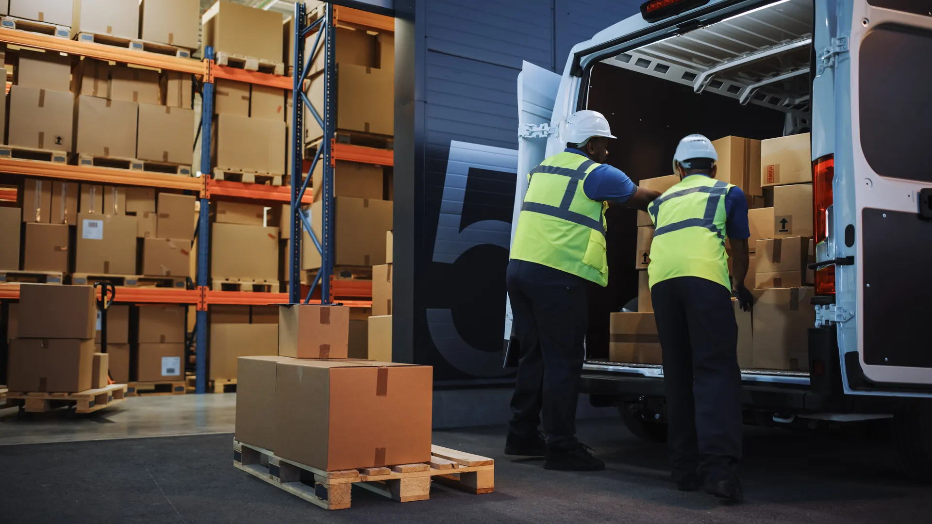 CS Logistics 2-man team loading a delivery van in warehouse